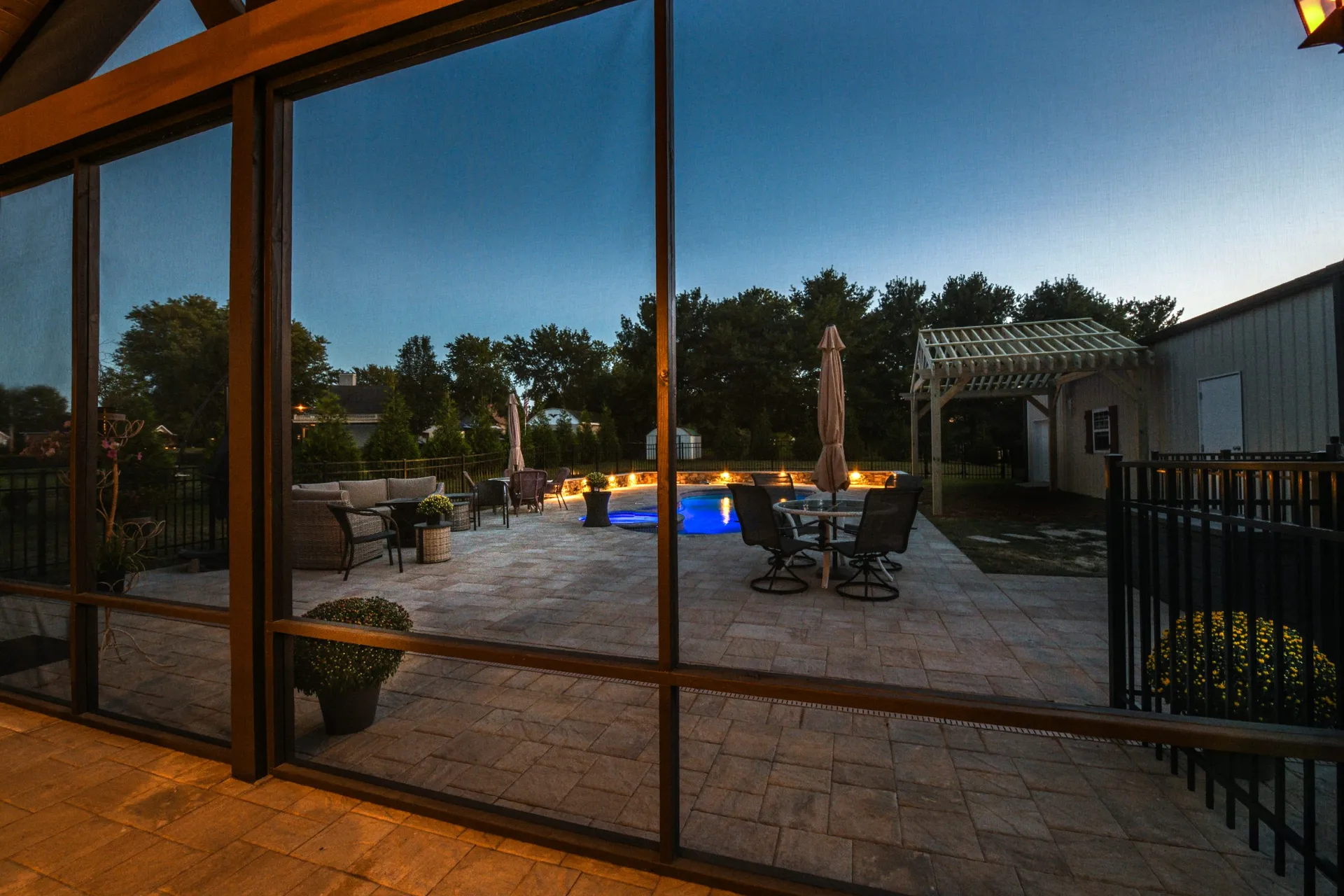 The pool seen from inside a screened porch