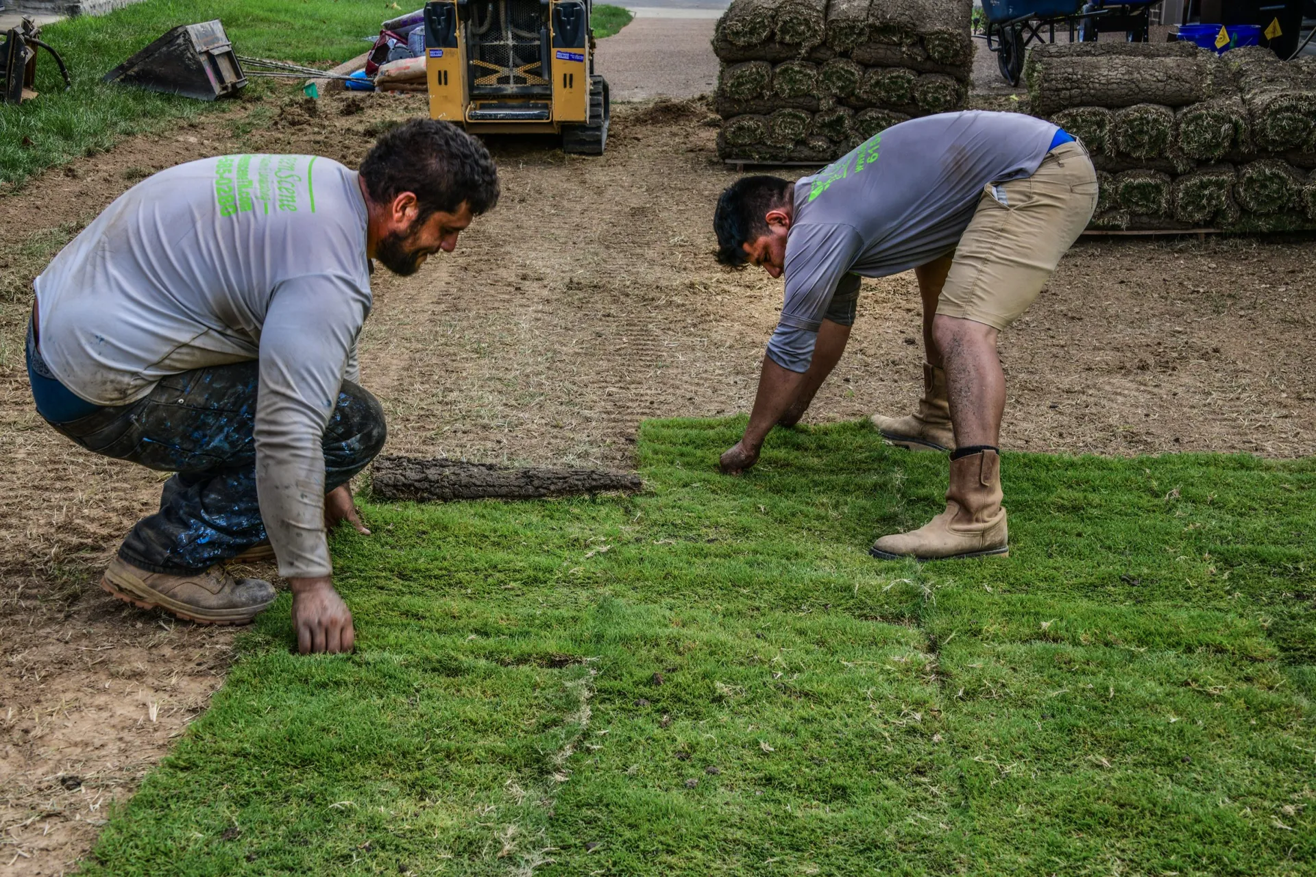 Two crewmen laying sod
