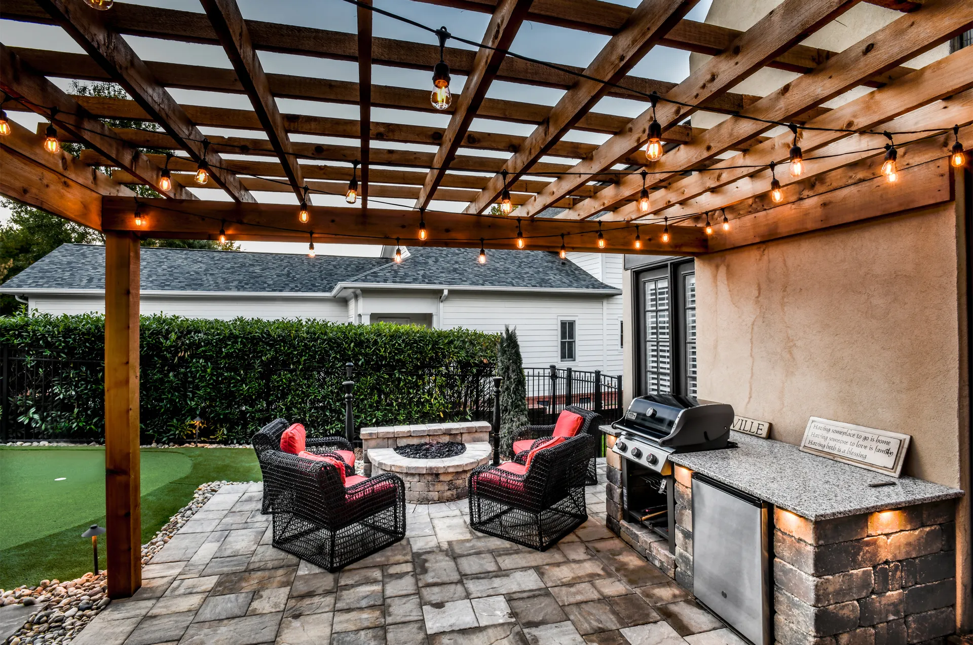 A pergola and outdoor kitchen in Westhaven lit at dusk